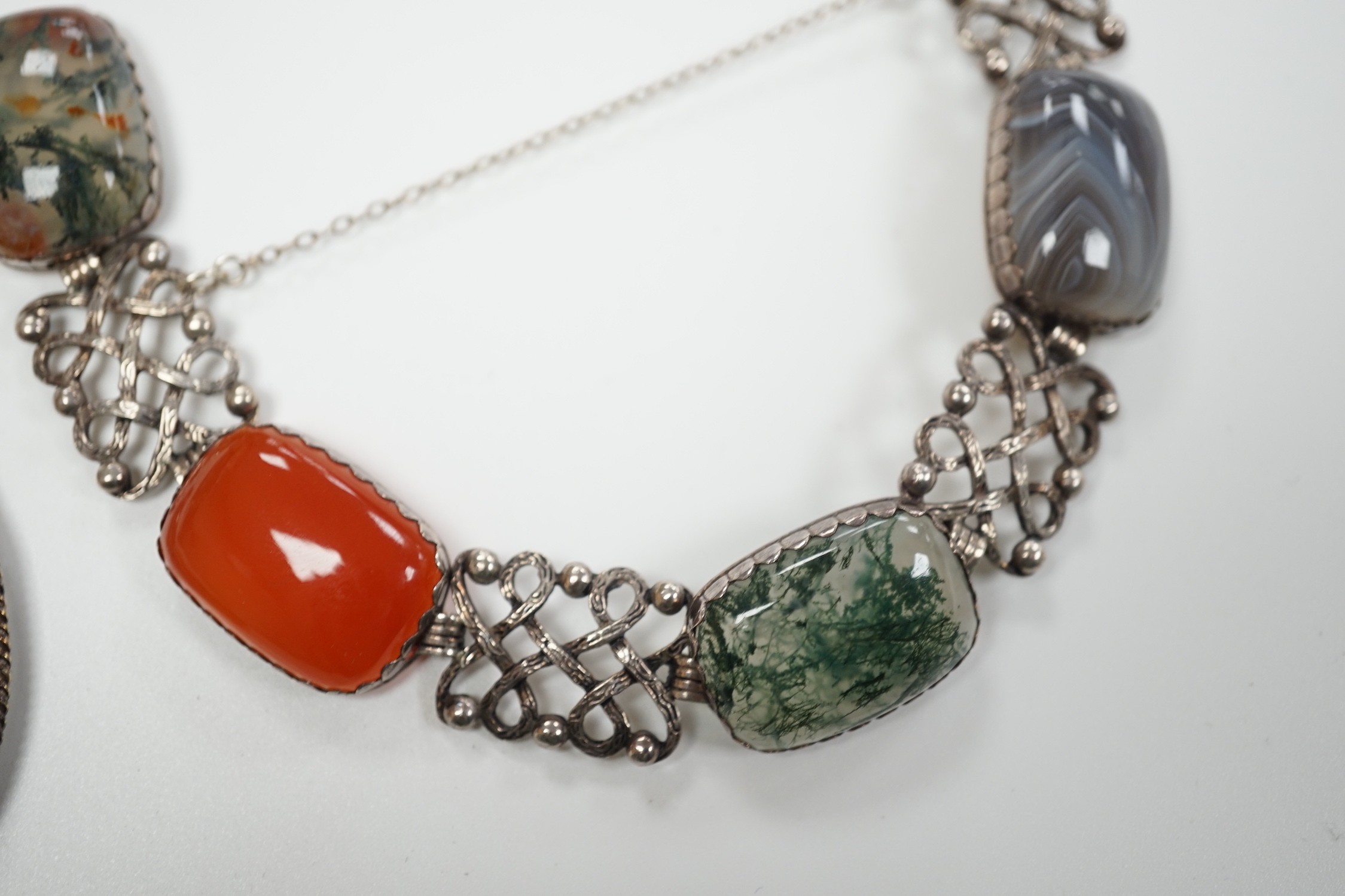 A pierced white metal and four stone agate set bracelet, 18.5cm and a white metal and banded agate set oval pendant.